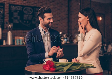 A happy man making proposal in a cafe Royalty-Free Stock Photo #594387890