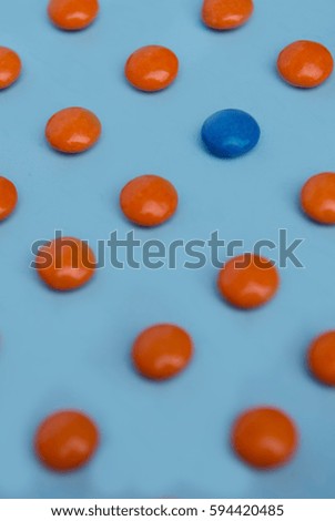 Picture of a lot of colorful sweeties candy over blue table background.
