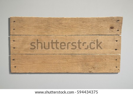 Wood sign with grey background.