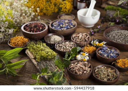 Natural remedy and mortar, healing herbs background Royalty-Free Stock Photo #594437918