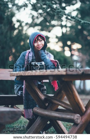 Fashionable female photographer in cold weather wearing colorful scarf