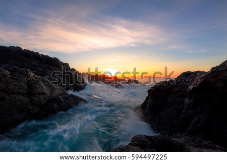 Beautiful winter sunrise at the rocky Pacific Ocean Shore. Picture taken in Amphitrite Point Lighthouse, Ucluelet, Vancouver Island, British Columbia, Canada.