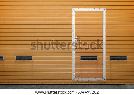 Yellow garage gate with ventilation grilles. Large automatic up and over garage door with inclusion of smaller personal door. Multicolor background set