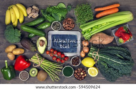 Alkaline foods above the wooden background Royalty-Free Stock Photo #594509624
