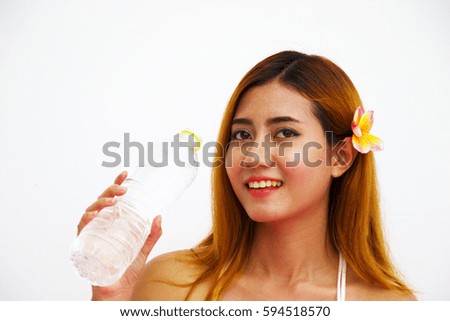 Woman is drink water from bottle. She is smiling .Drinking water, also known as potable water, is water that is safe to drink or to use for food preparation. 