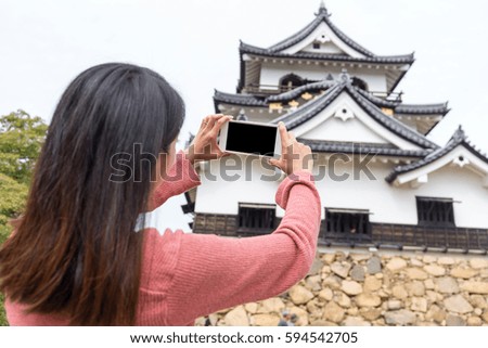 Woman taking photo on hikone castle
