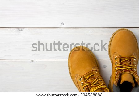 brown or yellow boots shoes for foot and adventure travel place on vintage white floor or table with copy space Royalty-Free Stock Photo #594568886