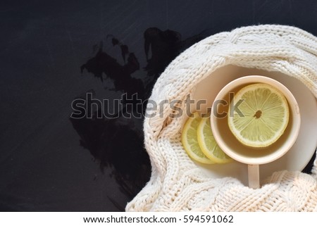 lemon tea with sweater on blackboard background