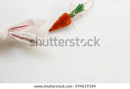 Easter spring bunny ears on white wooden background with carrots 