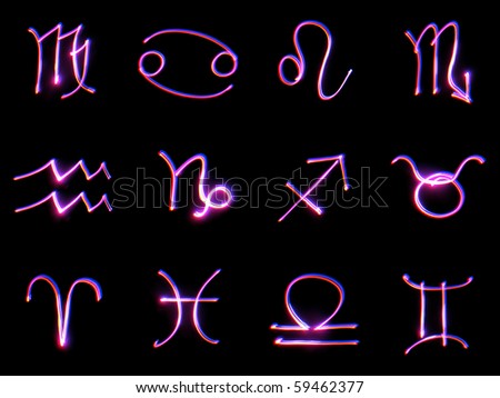 Signs of the zodiac on a black background. The technology of drawing with light - freezelight.