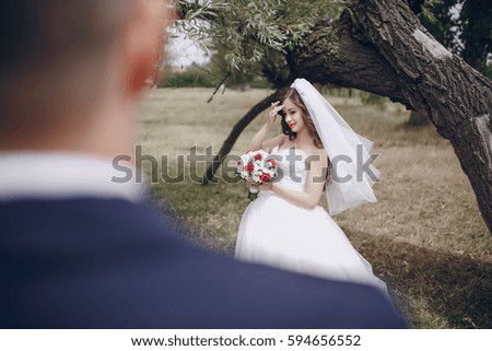 bride and groom near trees in nature