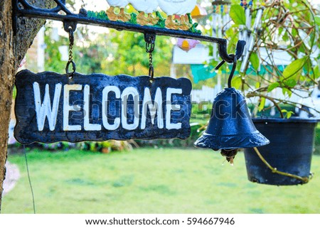 Welcome sign with iron bell.