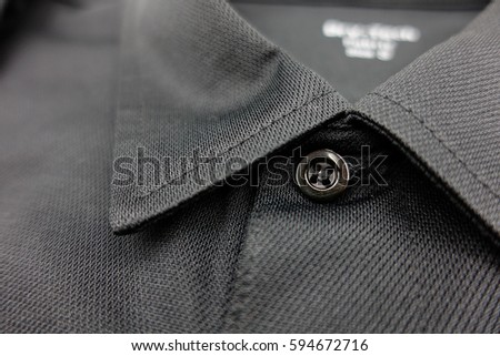 Detail of black polo shirt Royalty-Free Stock Photo #594672716