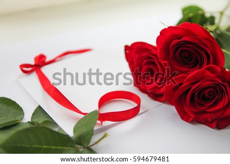 Congratulation with red roses on a light background