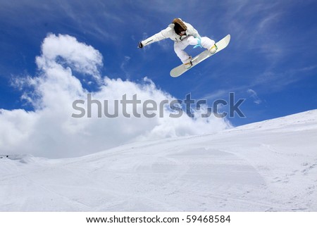Snowboarder jumping high in the air Royalty-Free Stock Photo #59468584
