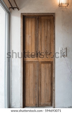Vintage wooden door on gray cement wall