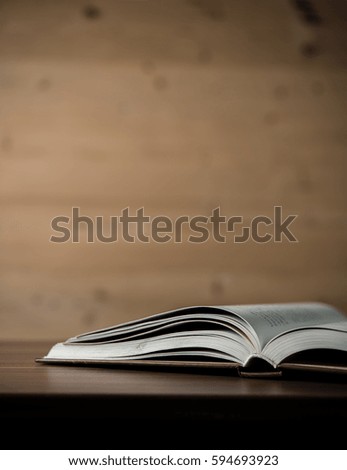 Close up of opened book on wooden table. Education concept.