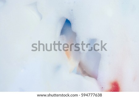 Background texture of a white foam with paints
