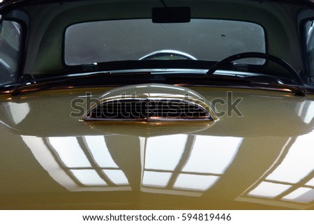 Detail of green shining car hood and windscreen