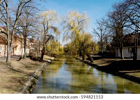 A quiet river dividing the city of Gyula, Hungary into two parts - an old town with a fortress and a new one.