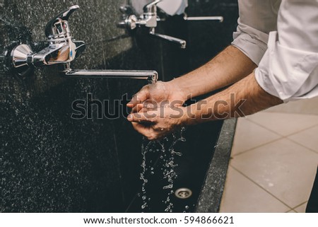 Muslim man washing his hands Royalty-Free Stock Photo #594866621