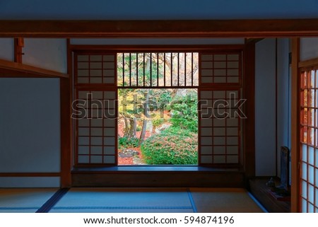 View of a Japanese courtyard garden through the sliding screen doors ( shoji ) of a room in Genko-an in Kyoto Japan, a Buddhist Temple famous for the colorful fall foliage in a peaceful Zen ambiance