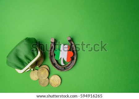 St. Patricks day, lucky charms. Horesechoe and shamrock on green background