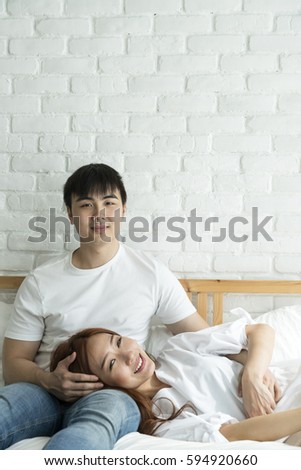 asian young love couple feeling happy in a bedroom