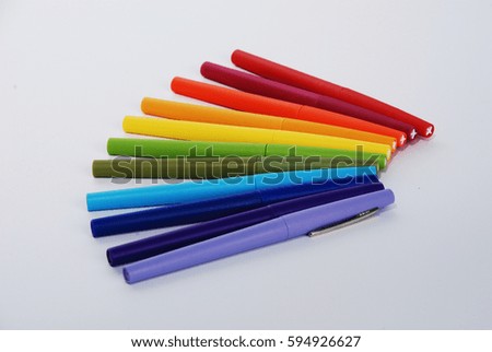 Rainbow colored fan of markers isolated on white background.
