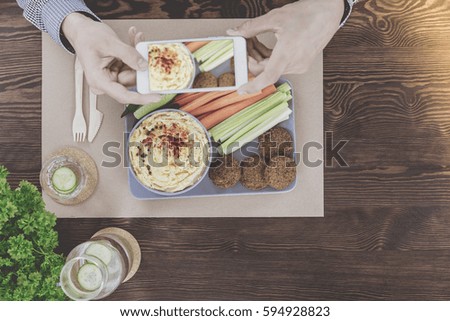 Vegetarian man doing food photo in the restaurant