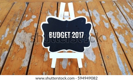 Business Concept - Chalk board with inscription BUDGET 2017 on a wooden table.  