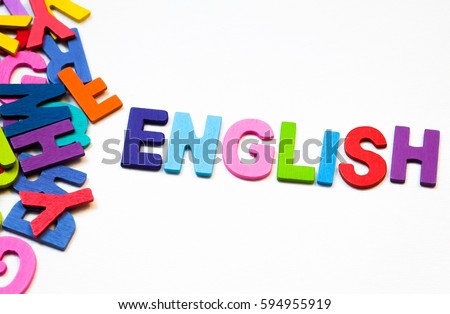 Word " English  " is beside the group of English letters made by colorful wooden on white background. English language learning concept
