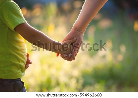 Mother and son holding hand in hand 