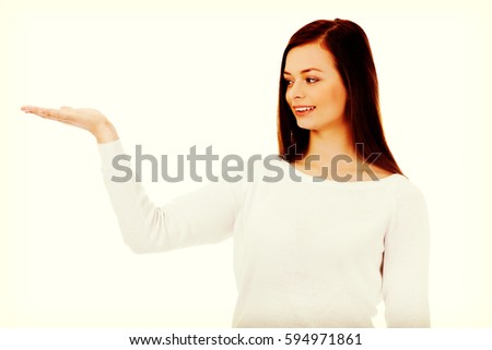 Smiling young woman presenting something on open palm