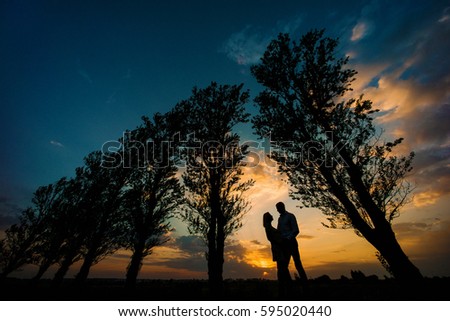 Silhouettes of lovers in the nature