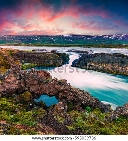 Picturesque summer morning scene on the Godafoss Waterfall. Colorful sunrise on the on Skjalfandafljot river, Iceland, Europe. Artistic style post processed photo.