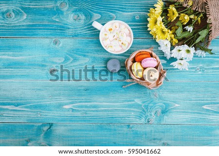 Macarons and mug with hot chocolate and marshmallows