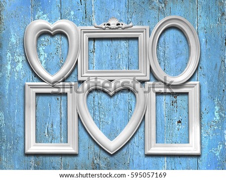 Decorative white photo frames on a blue wooden background