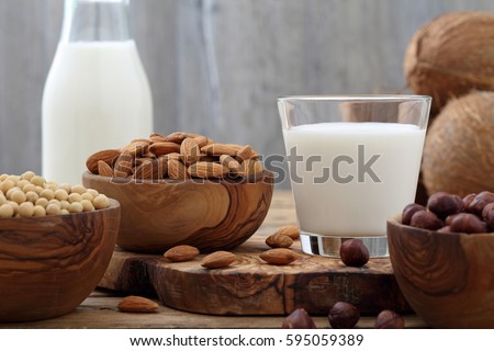 milk of nuts on rustic wooden table background Royalty-Free Stock Photo #595059389