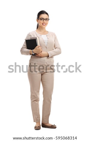 Full length portrait of a young female teacher looking at the camera and smiling isolated on white background