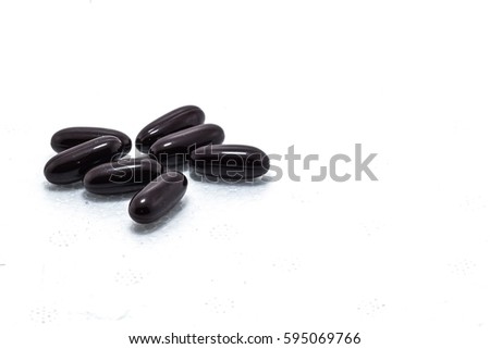 Medical and medicine concept. Black capsul on white background.