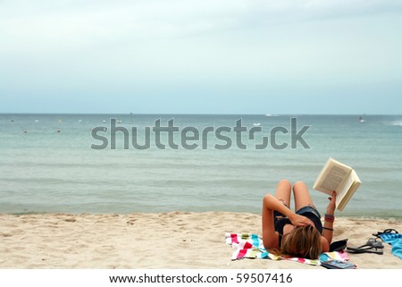 Bikini Girl Reading book in relax mood on the Tropical beach, Samui Thailand