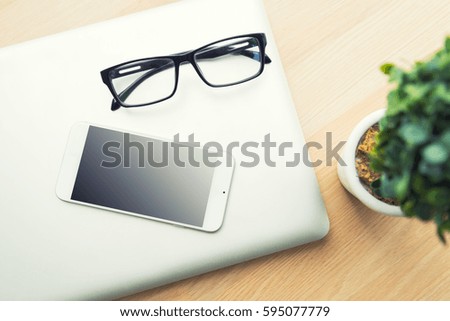 glasses and tablet on a wood table