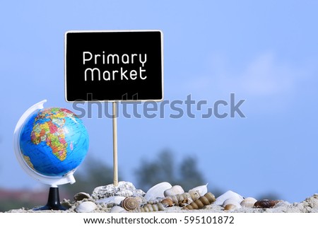 Marketing concept, word PRIMARY MARKET on black sign frame with globe and shells on blue sky background