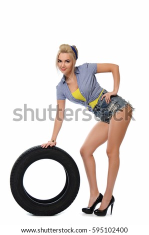 Girl with automobile tyres isolated on white