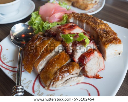 crispy pork, bbq pork and grilled duck on the plate, chinese food Royalty-Free Stock Photo #595102454