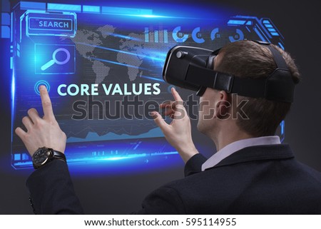Business, Technology, Internet and network concept. Young businessman working on a virtual screen of the future and sees the inscription: Core values
