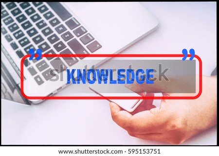Hand and text  "KNOWLEDGE" with vintage background. Technology concept.