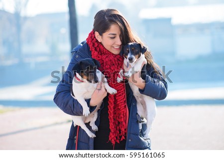 Beautiful and happy woman enjoying with dogs.Colored photo