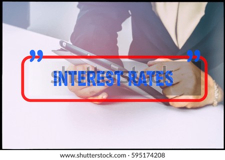 Hand and text  "INTEREST RATES" with vintage background. Technology concept.